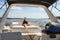 Soaking up the sun - a woman in a bathing suit enjoys the sun on her face as she sits in the back of a yacht as it speeds across t