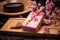 a soap bar on a bamboo mat with a cherry blossom branch next to it