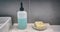 Soap bar versus liquid hand soap bottle comparison of hand washing products on home bathroom vanity counter banner