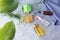 Soap, bottles with an antiseptic and aromatic oil, medicinal chamomile flowers on a gray background