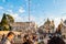 Soap bubbles flying on Piazza del Popolo, People Square in Rome full of happy positive people, tourists and locals with Roman
