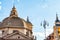 Soap bubbles flying on Piazza del Popolo, People Square in Rome surrounded by ancient churches like Santa Maria in Montesanto with