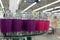 Soap dish dispenser for liquid soap, bathroom pastic and metal accessories in purple and pink colors on glass shelve in store clos