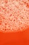 soap foam close-up on orange background. Beauty and hygiene .soap foam macro background.soap bubbles.Bath foam