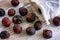 Soap nuts spilling from textile bag on wooden background.