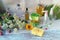 Soap, spray, bouquet of medicinal herbs and glass bottles with aromatic oil on a wooden table