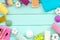 Soap, tooth brush, bath bomb and cotton towels for body care and washing on mint green wooden background top view mockup