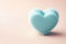 A soapy sponge in the shape of a heart on a clean background. Space for text.