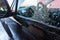 Soapy water drains from the car. A man washes a hand car wash with water under pressure in a car wash outside in a hangar for a ca