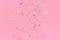 Soaring down colorful sprinkles over pink background