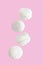 Soaring white zephyr marshmallow on pink background, food levitation