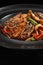 Soba beef and vegetables, Buckwheat noodles on a dark stone background. Asian cuisine, Wok menu.