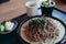 Soba noodles with soup on wooden tray