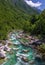 Soca Valley, Slovenia - Aerial panoramic view of the emerald alpine river Soca on a bright sunny summer day with green foliage.