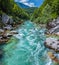 Soca Valley, Slovenia - Aerial panoramic view of the emerald alpine river Soca with rafting boats going down the river at summer