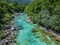 Soca Valley, Slovenia - Aerial view of the emerald alpine river Soca with rafting boats going down the river on a summer day