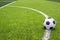 Soccer ball on artificial bright and dark green grass at public