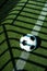 Soccer ball black and white on artificial ground ground with shadows stripes, on the line