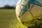 Soccer ball in close up with the goal in the background out of focus in a 5-a-side football field