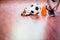 Soccer ball with futsal player sitting and tying sport shoelaces in stadium hall