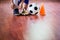 Soccer ball with futsal player sitting and tying sport shoelaces in stadium hall