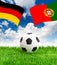 Soccer ball on green grass and flags of germany and portugal