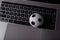 Soccer ball on a laptop`s keyboard. Sport, gambling, money win concept