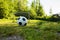 Soccer ball on penalty spot in natural football ground