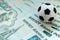 A soccer ball on Russian banknotes of one thousand rubles. The concept of corruption, bribes or sports betting. Close up.