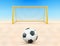 Soccer ball on sand field in front of goal post, front view