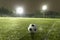 Soccer ball on sports field at night