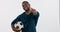 Soccer, black man and thumbs up sign isolated in studio for workout, training or exercise. Portrait, football athlete