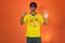 Soccer Brazilian  Fan Celebrating Isolated on Orange Background