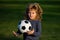 Soccer child play football. Boy holding soccer ball, close up sporty kids portrait.