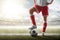 Soccer closeup. Leg of soccer player on the ball. Soccer background. Day stadium. Sport