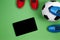 Soccer football background. Top view of two soccer players shoes, soccer ball and tablet computer on green background