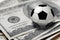 Soccer or football ball on 100 dollars bills closeup