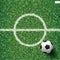 Soccer football ball on green grass of soccer field with center line area. Vector