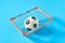 Soccer, football ball in metal market basket on blue background