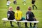 Soccer Football Bench. Young Footballers Sitting on Football Substitute Bench.