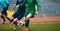 Soccer football players competing for ball and kick ball during match in the stadium