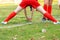 Soccer girl goalkeeper in grass field during game. Net view.