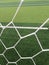 Soccer goal net against green background