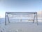 Soccer goal in picturesque winter scenery covered in deep snow