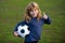 Soccer kid boy playing football show thumbs up success sign. Boy holding soccer ball, close up sporty kids portrait.