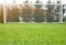 A soccer net with shot in bright sunlight with trees