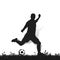 Soccer player with ball on the grass makes a punch, silhouette o