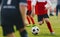 Soccer Player Dribbling, Young Footballer in Run with Ball. Boys Kicking Sports Soccer Game on Sunny Summer Day