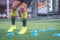 Soccer player feet training with marker in soccer academy field