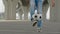 Soccer player in jeans is practicing kicks tricks juggling ball, legs close-up.